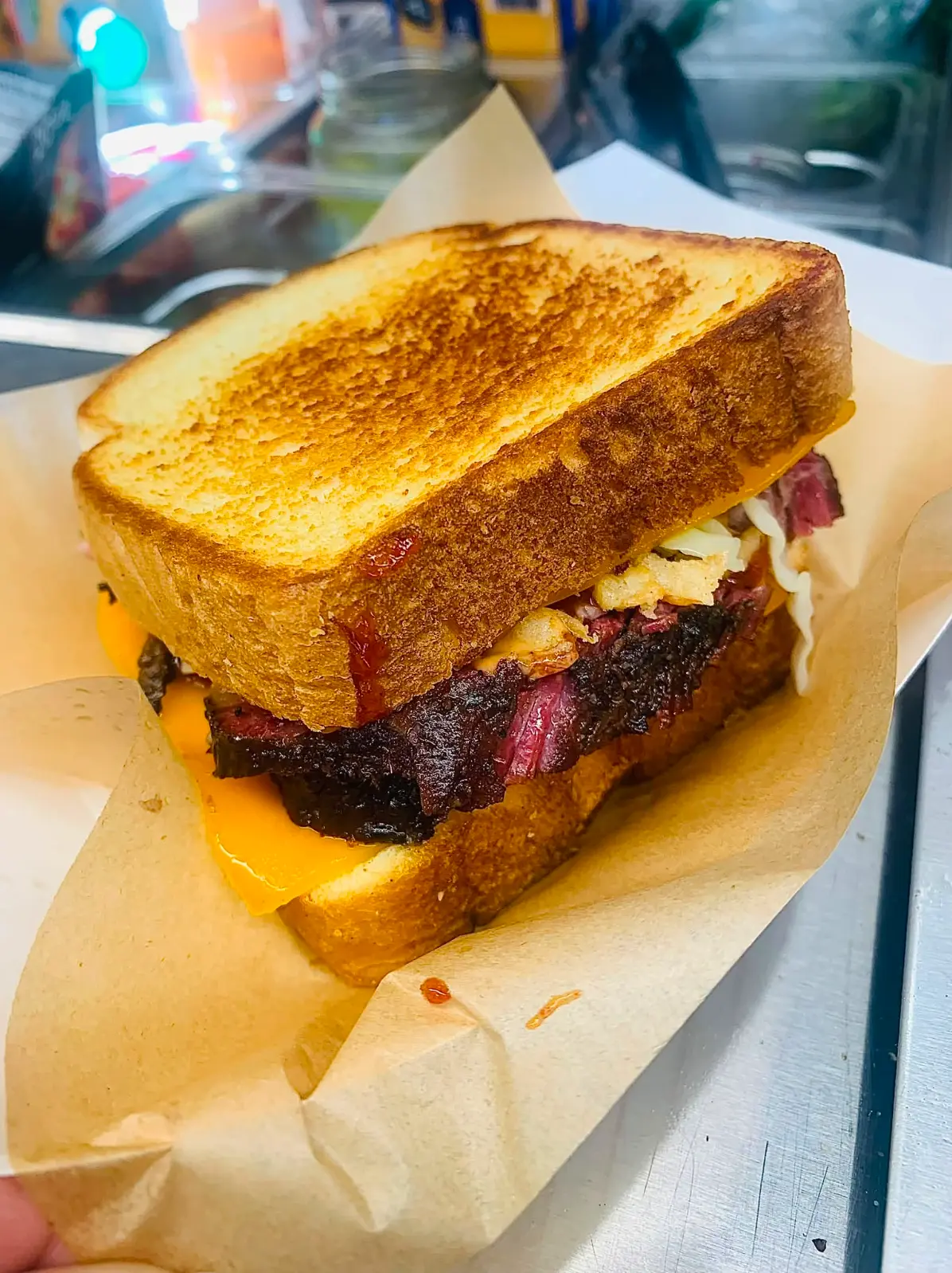 Queso brisket melt on toasted bread with thick-cut brisket